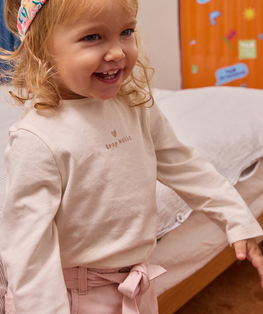 Baby girls' cream t-shirt in organic cotton with a sequinned message